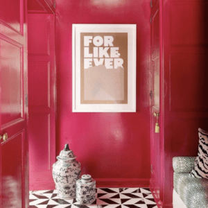 Bright deep pink colored walls and black and white tiled flooring.