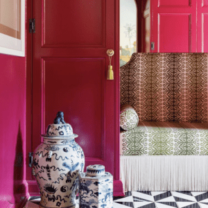 Seating area with vibrant colored walls and eclectic vases.
