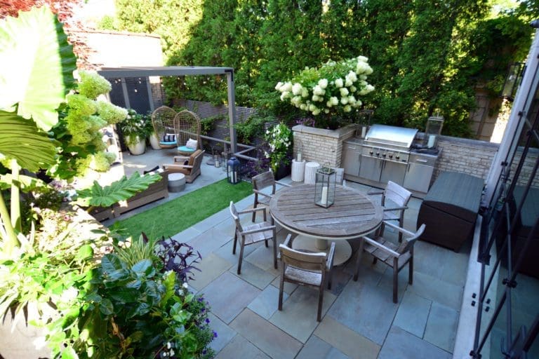 Chic looking patio with an outdoor kitchen and dining table.