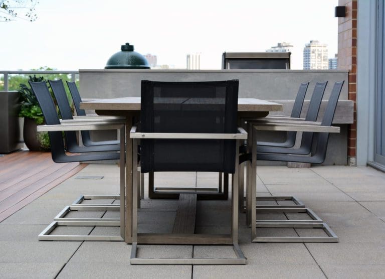 Close up of an outdoor dining table on a roof deck.