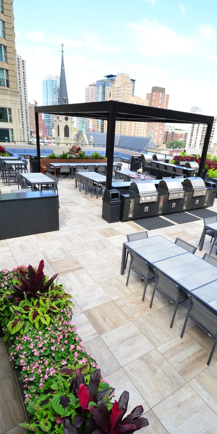 Overhead view of a roof deck with an outdoor kitchen and pergola cover.