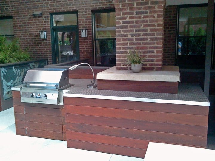 Outdoor kitchen with grill and heat lamp.