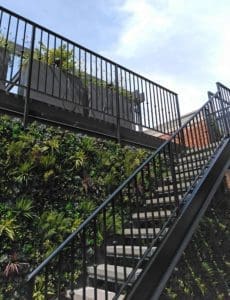 Metal stairs leading to a roof deck.