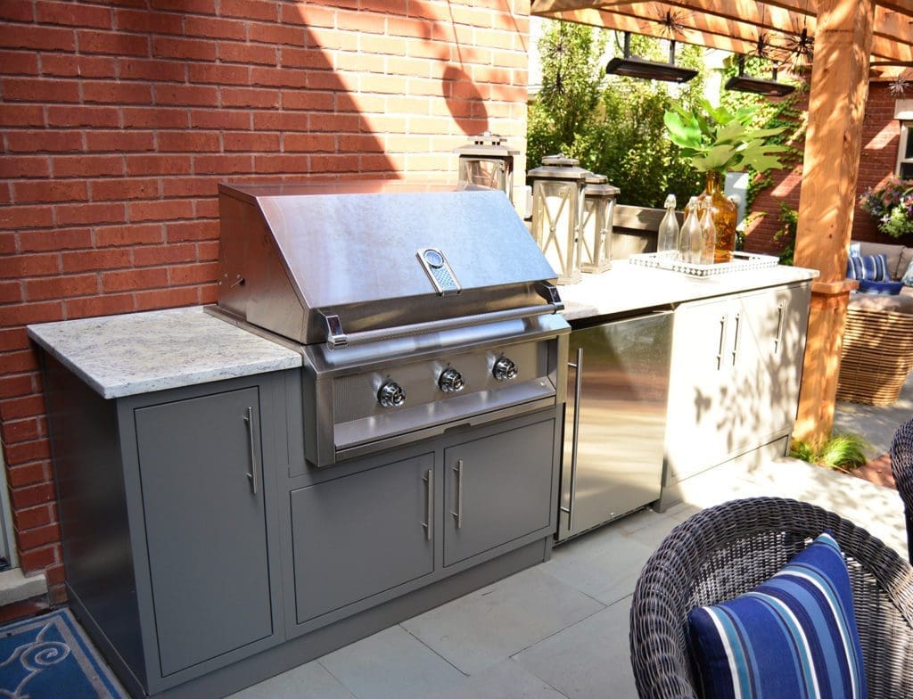 Outdoor kitchen with grill and pergola.