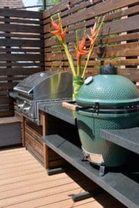 Two grills in an outdoor kitchen area.