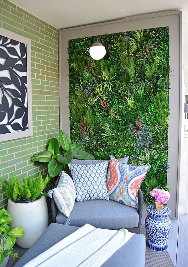 Greenery wall with seating area beside it.