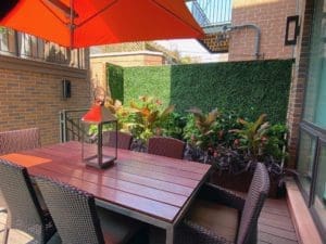 Outdoor dining area with an orange umbrella.