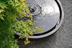 Small decorative round water bubbler fountain.