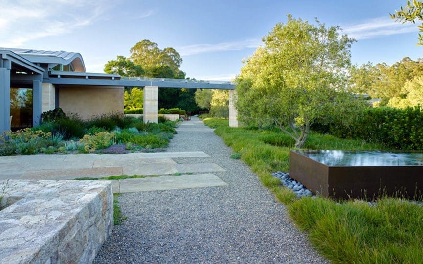 Mix of pavers and rocks creating a walkway outside of a home.