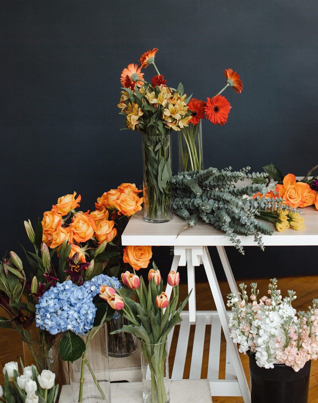 Floral designer table with various bouquets in vases.