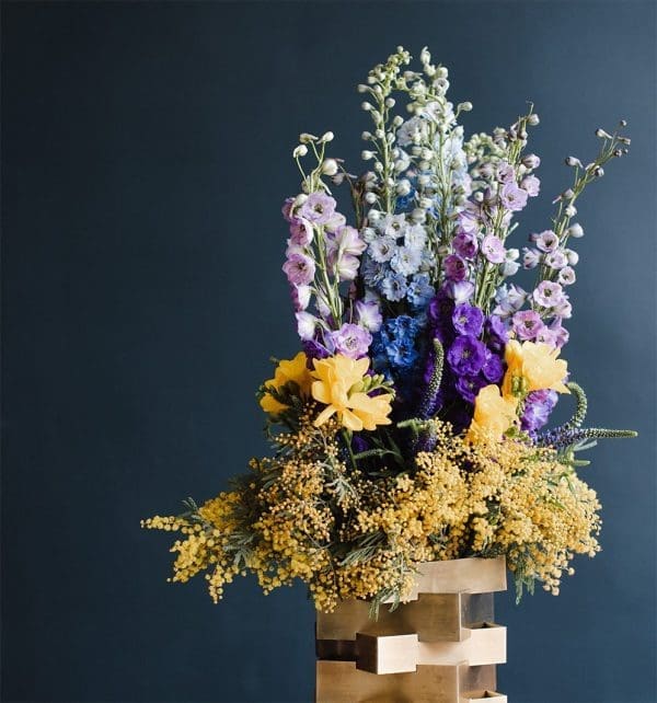 Floral arrangement in a geometric vase.