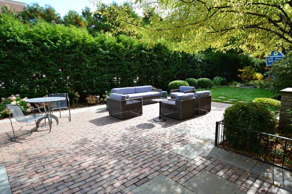 Outdoor seating area with clay pavers.
