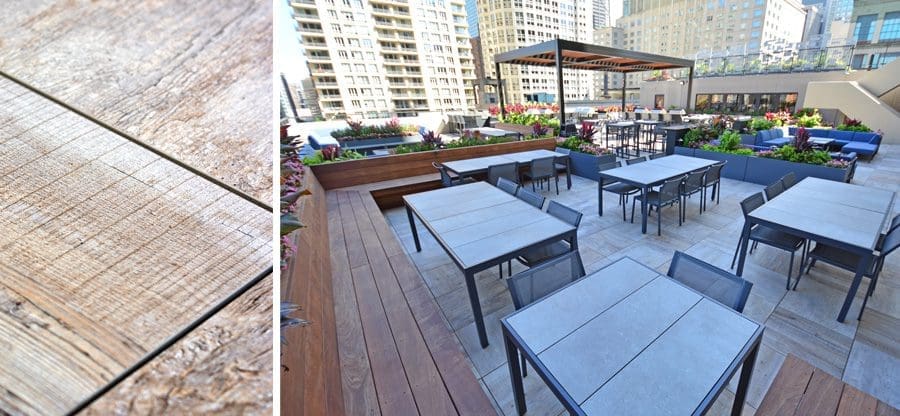Outdoor rooftop seating area with lots of tables and couches.