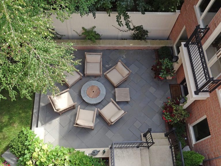 Overhead view of a patio seating area with a round fire pit.