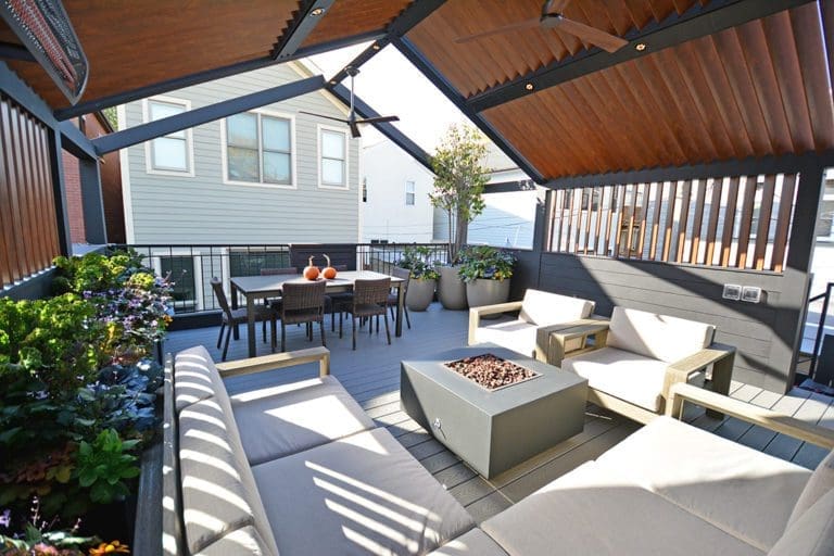 Outdoor roof deck with a covered roof and square gas fire pit.