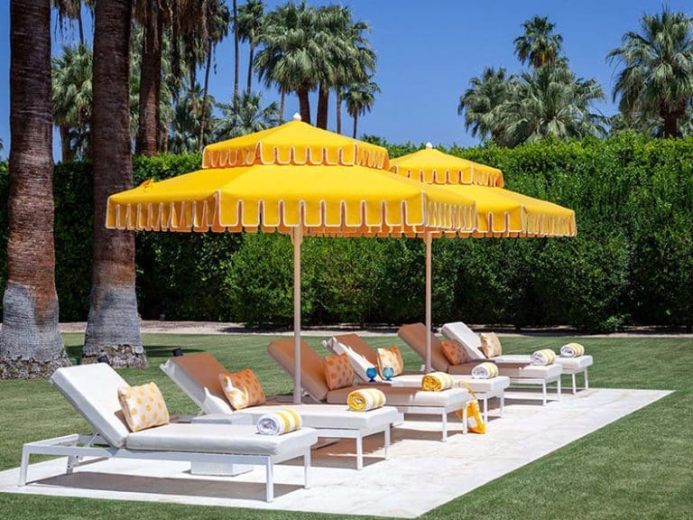 Yellow fringed umbrellas with lounge seating beneath.