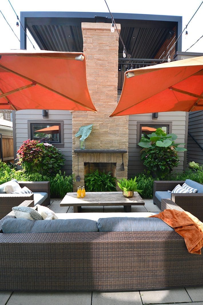 Outdoor patio with seating and orange umbrellas.
